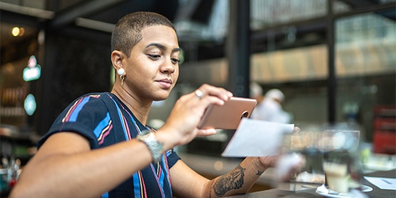 Woman depositing check with a mobile phone