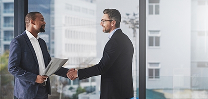 Two businessmen shaking hands at work