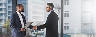 Two businessmen shaking hands at work