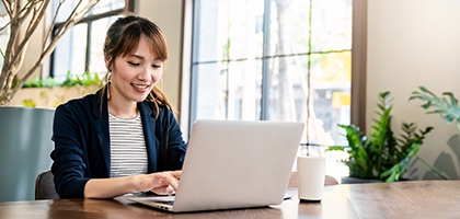 Businesswoman working on laptop at office desk