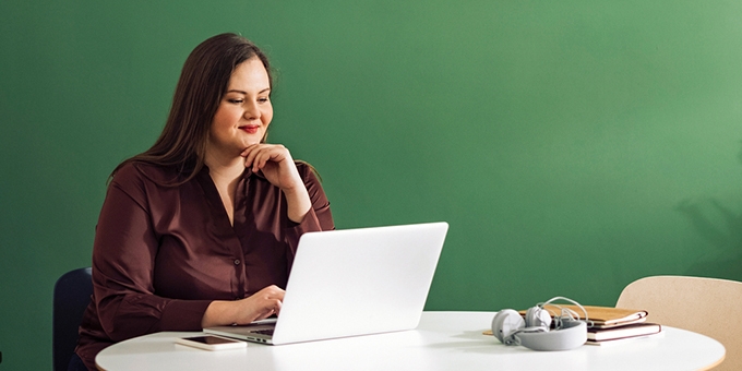 Businesswoman working on laptop at a table