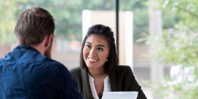 Banker talking with client in office