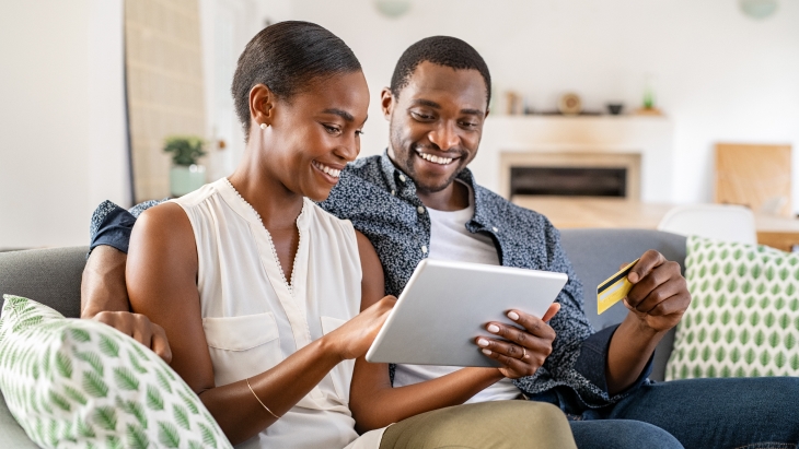 Couple using a credit card for online shopping.