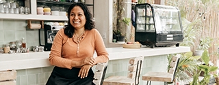 Business owner sitting at cafe bar stool