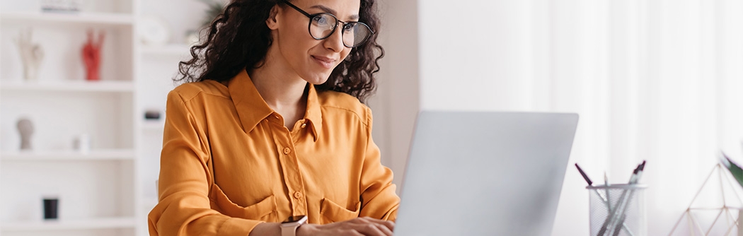 Businesswoman sitting in an office with a laptop