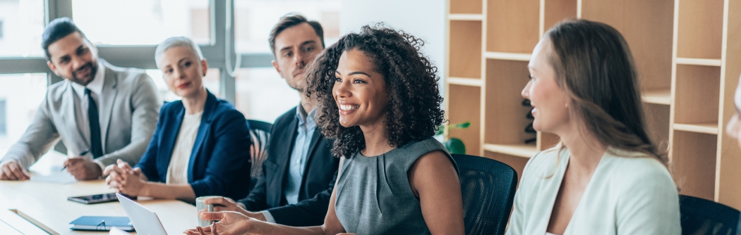 Team of businesspeople sitting together at a meeting in the office.