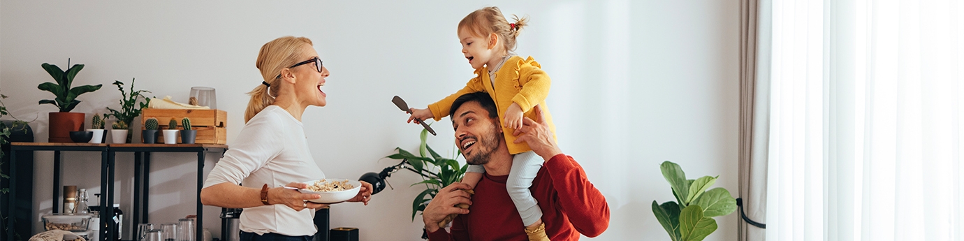 Family playing while cooking in the kitchen.