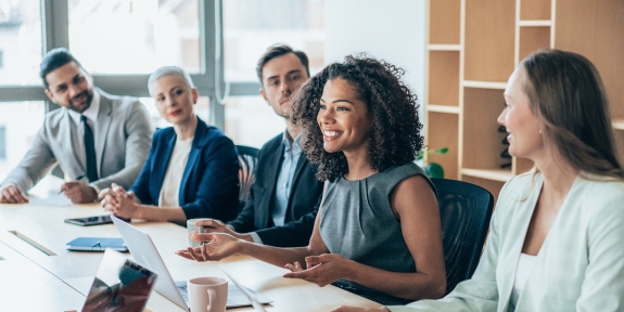 Team of businesspeople sitting together at a meeting in the office.