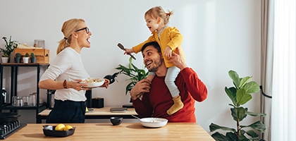 Family playing while cooking in the kitchen