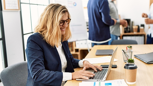 Woman working on laptop in an office