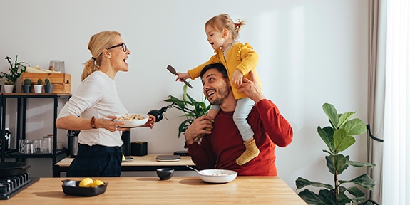 Family playing while cooking in the kitchen