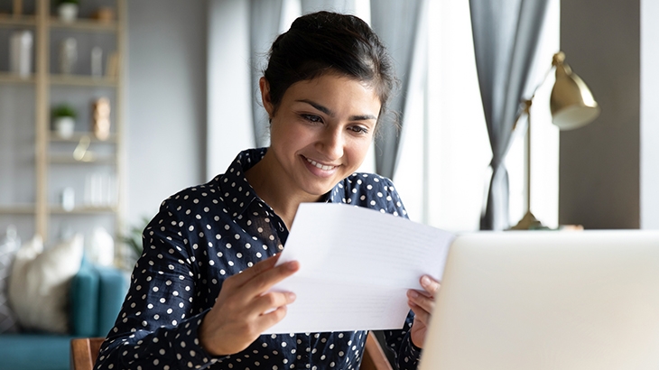 Woman reading bank statement letter.