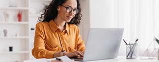 Businesswoman sitting in an office with a laptop