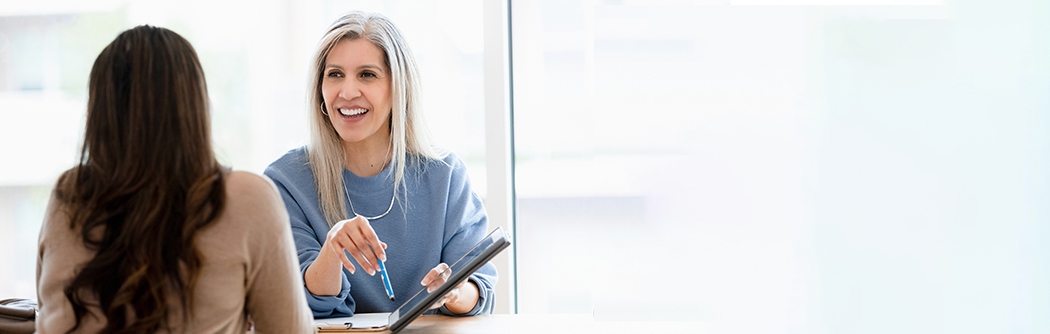 Businesswoman talking with client in office.