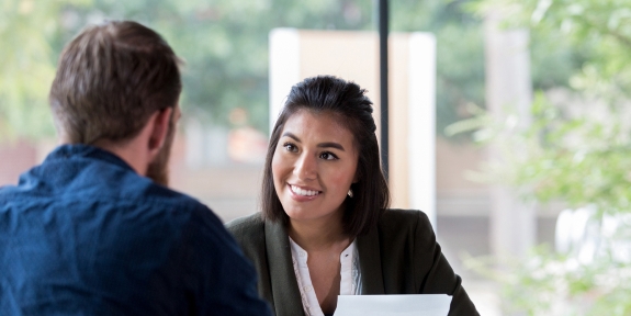 Banker talking with client in office