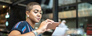 Woman depositing check with a mobile phone