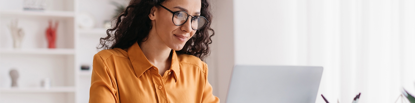 Businesswoman sitting in an office with a laptop