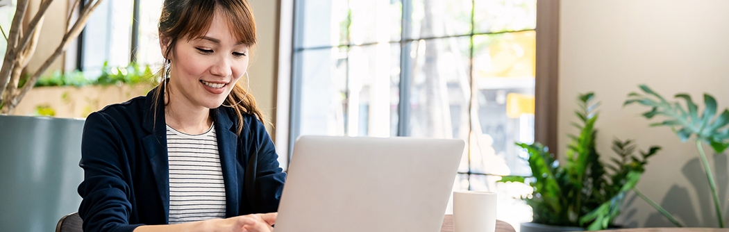 Businesswoman working on laptop at office desk