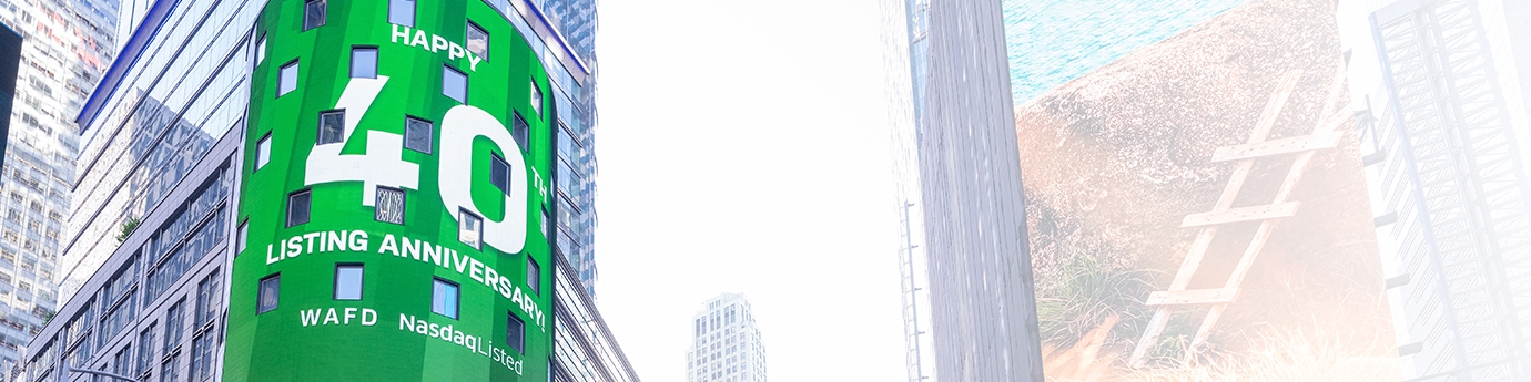 WaFd employees in Times Square NYC with WaFd Nasdaq sign