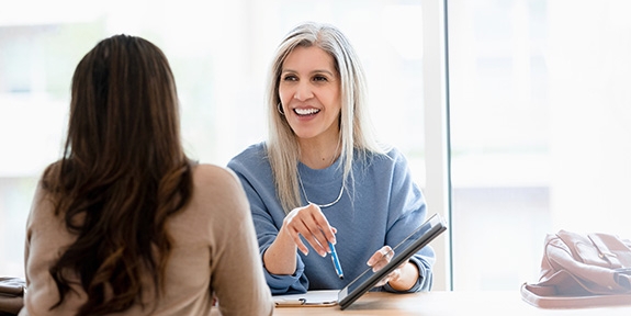 Businesswoman talking with client in office.