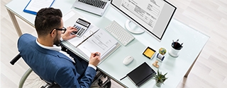 Businessman in a wheelchair at a desk.