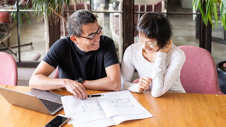 Couple talking about the floor-plan of their new house.