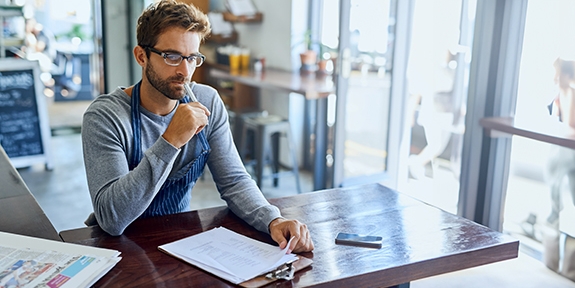 Business owner doing accounting in his shop.