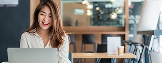 Businesswoman using her laptop in the office