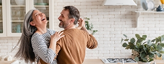 Happy couple dancing together in the kitchen