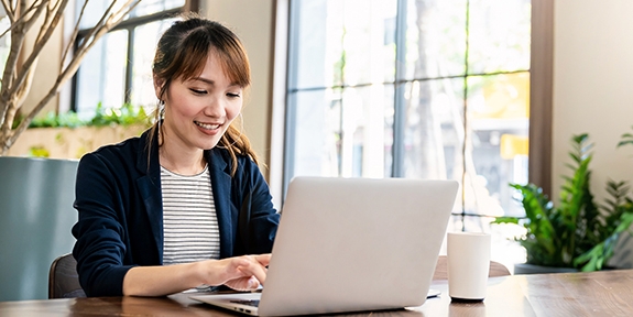 Businesswoman working on laptop at office desk