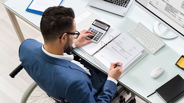 Businessman in a wheelchair at a desk