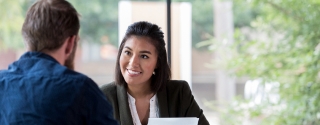 Banker talking with client in office