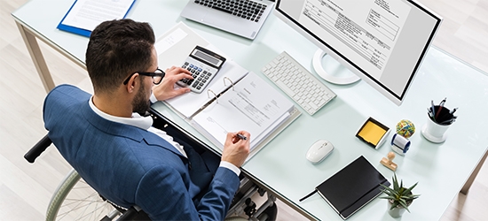 Businessman in a wheelchair at a desk.