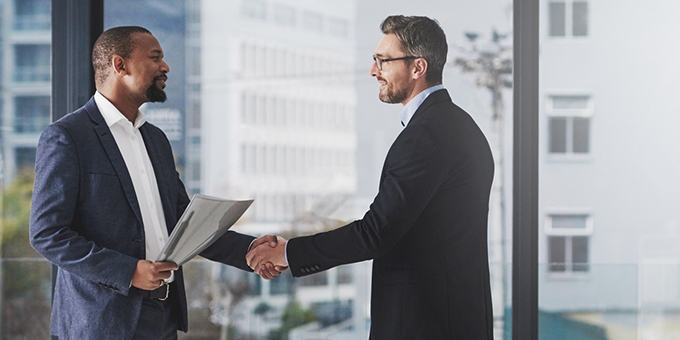 Two businessmen shaking hands at work