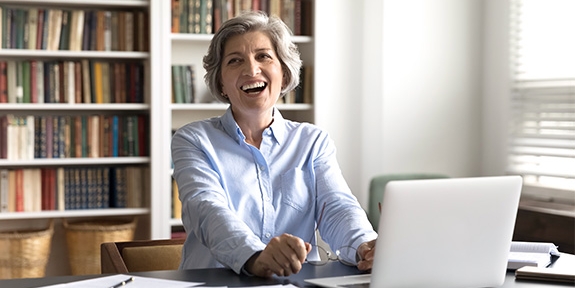 People in conference room talking during meeting with laptops