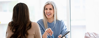 Businesswoman talking with client in office.