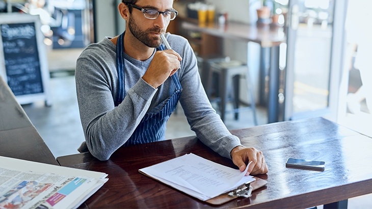 Business owner doing accounting in his shop.