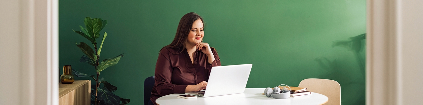 Businesswoman working on laptop at a table