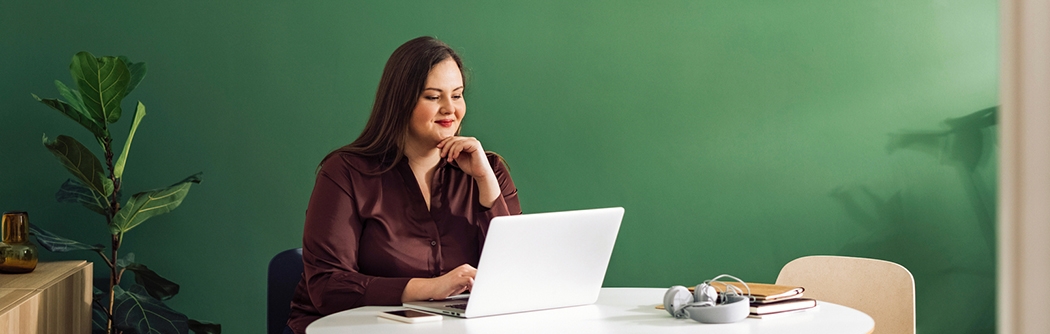 Businesswoman working on laptop at a table