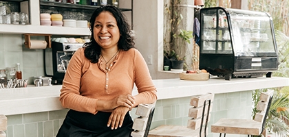 Business owner sitting at cafe bar stool