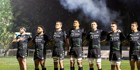 Seawolves team standing together on field.