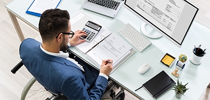 Businessman in a wheelchair at a desk.