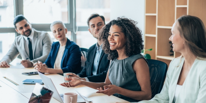 Team of businesspeople sitting together at a meeting in the office.