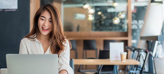 Businesswoman using her laptop in the office