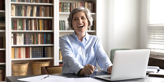 People in conference room talking during meeting with laptops