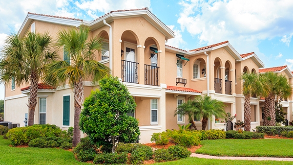 Senior housing building with tropical trees on a sunny day