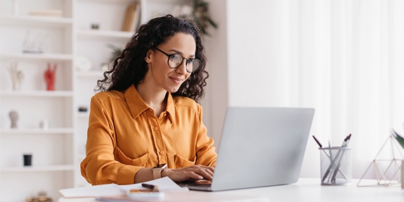 Businesswoman sitting in an office with a laptop