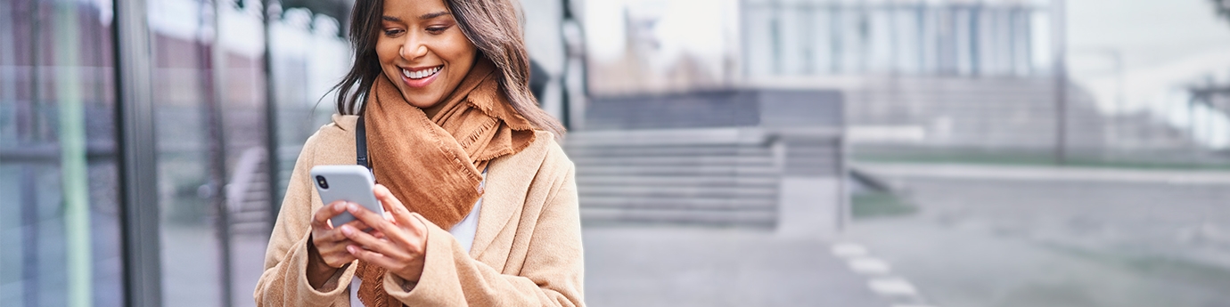 Woman walking outside while on a mobile phone.