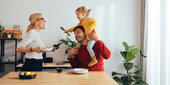 Family playing while cooking in the kitchen.