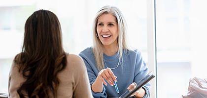 Businesswoman talking with client in office.